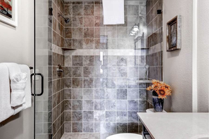 Bathroom featuring vanity, toilet, and a shower with shower door