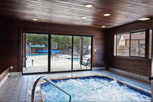 View of pool with an indoor hot tub