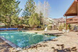 View of swimming pool featuring a mountain view and a patio area