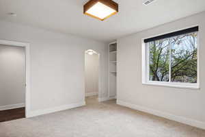 Unfurnished bedroom with carpet flooring