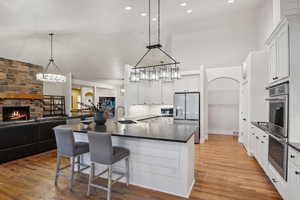 Kitchen with white cabinetry, light hardwood / wood-style floors, appliances with stainless steel finishes, and kitchen peninsula