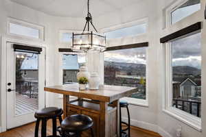 Dining room featuring a mountain view, wood-type flooring, and an inviting chandelier