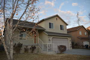 View of front of home featuring a porch and a garage