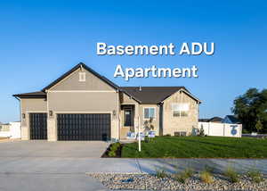 View of front of property featuring a front lawn and a garage