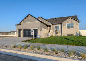 View of front of home featuring a garage and a front lawn