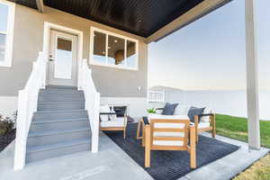 Patio terrace at dusk featuring an outdoor living space