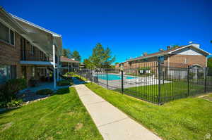 View of pool with a yard and a patio