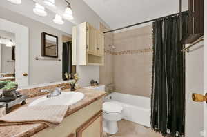 Full bathroom featuring vanity, toilet, and shower / bath combo