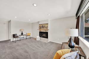 Sitting room featuring carpet and a fireplace