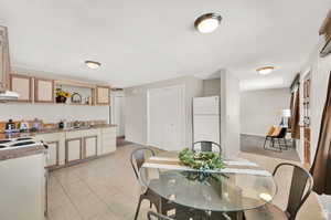 Tiled dining room featuring sink