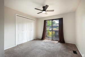 Unfurnished bedroom with carpet flooring, a closet, and ceiling fan