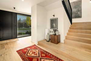 Foyer entrance with hardwood / wood-style floors