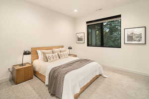 Bedroom featuring light colored carpet