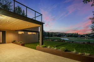 Patio terrace at dusk with a yard