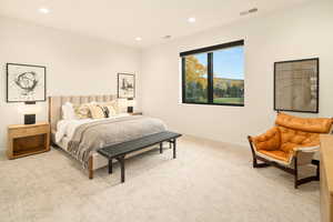 Bedroom featuring light carpet