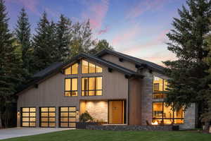 Contemporary house featuring a yard and a garage