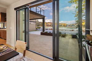 Doorway with light hardwood / wood-style flooring and a wealth of natural light