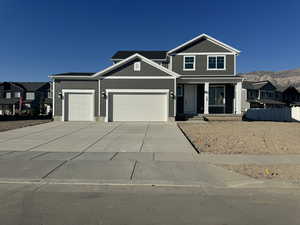 View of front facade featuring a mountain view and a garage