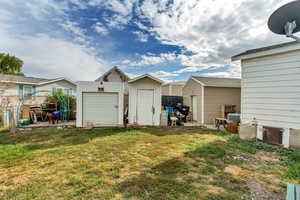 View of yard featuring a shed and central AC