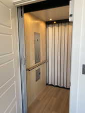 Room details featuring wood-type flooring and elevator