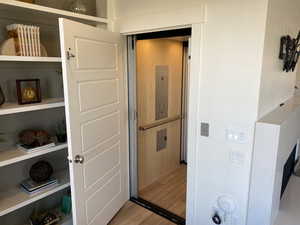 Interior space with elevator and wood-type flooring