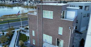 View of home's exterior with a water view