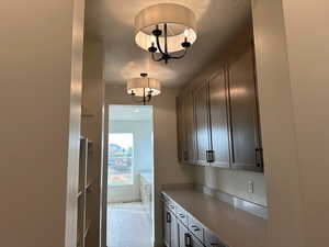 Kitchen with decorative light fixtures and a textured ceiling