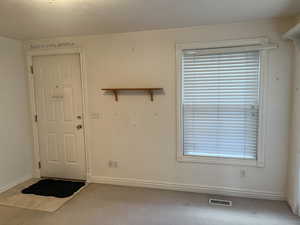 Entrance foyer featuring carpet floors