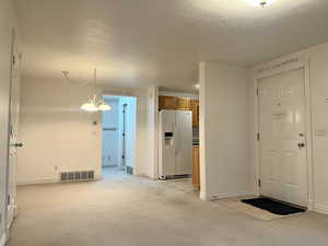 Carpeted spare room with a textured ceiling