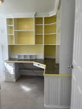 Unfurnished office with crown molding and carpet