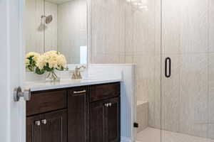 Bathroom featuring vanity and an enclosed shower