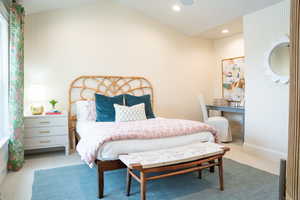 Carpeted bedroom with lofted ceiling