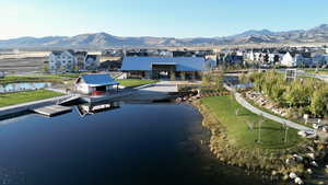 Birds eye view of property with a water and mountain view