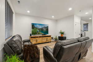 Living room with light hardwood / wood-style flooring