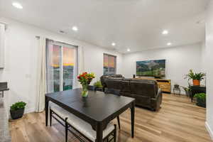 Dining area with light hardwood / wood-style flooring