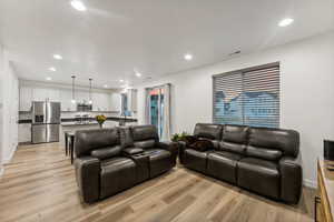 Living room with light hardwood / wood-style floors