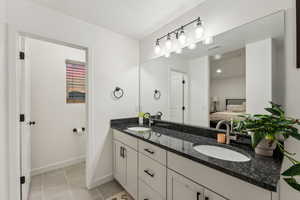 Bathroom with vanity, a textured ceiling, and tile patterned flooring