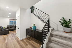 Stairs featuring hardwood / wood-style floors