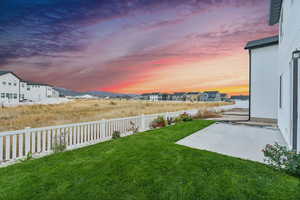 Yard at dusk with a patio area