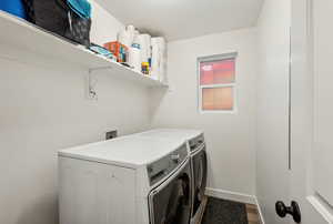 Washroom featuring independent washer and dryer, wood-type flooring, and a textured ceiling