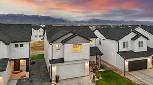 Modern inspired farmhouse with a garage, a mountain view, and central AC unit