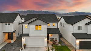 Modern farmhouse style home with a garage, a mountain view, and central air condition unit