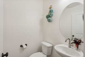 Bathroom featuring sink and toilet