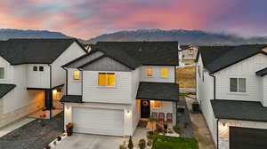 Modern inspired farmhouse with a mountain view, central AC unit, and a garage