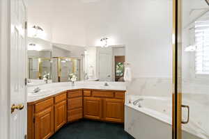 Bathroom featuring vanity and shower with separate bathtub