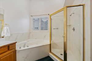 Bathroom with vanity and independent shower and bath