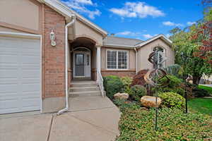 Doorway to property with a garage