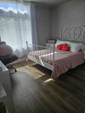 Bedroom featuring hardwood / wood-style floors and multiple windows