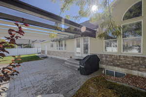 View of patio featuring grilling area and a pergola