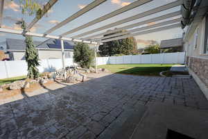 Patio terrace at dusk featuring a lawn and a pergola